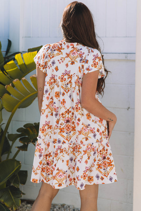 Minivestido con estampado floral geométrico color albaricoque, ribete con volantes y mangas con volantes