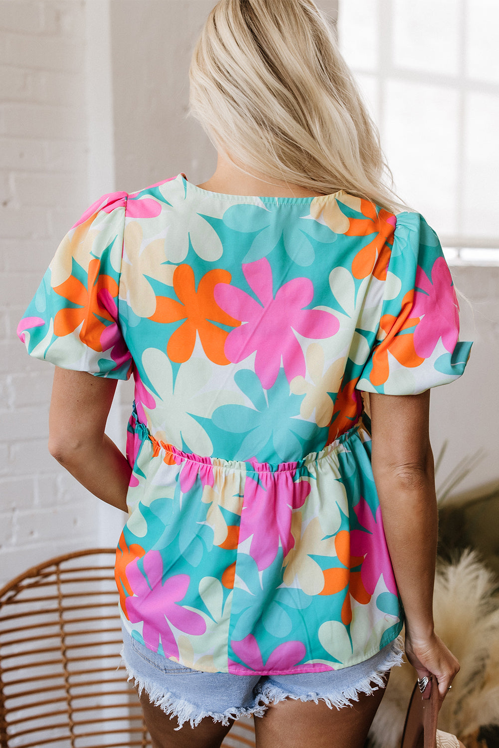 Blusa peplum con estampado floral rosa, cuello en V y mangas abullonadas