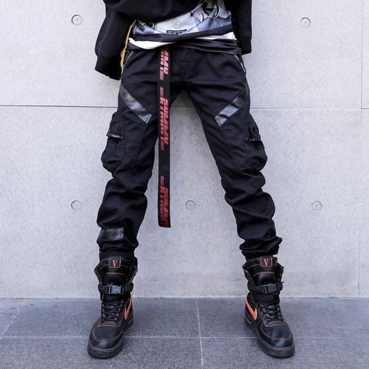 Pantalones cargo casuales de hombre de moda callejera de piel sintética con bolsillo de empalme
