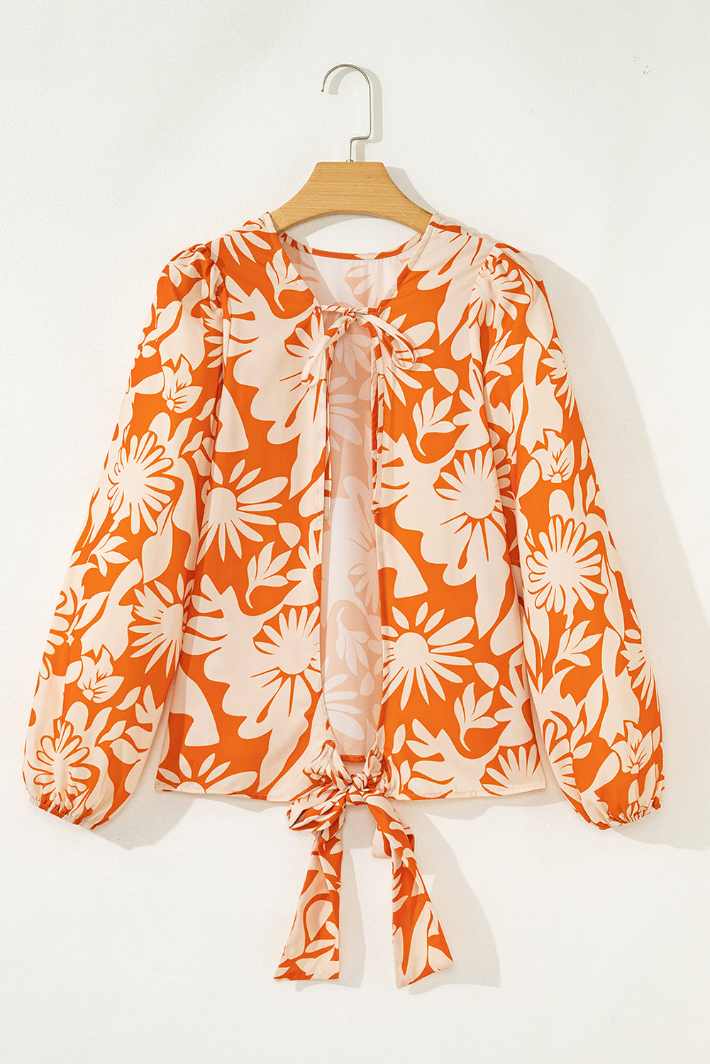 Blusa naranja de manga larga con estampado floral, nudo y espalda abierta