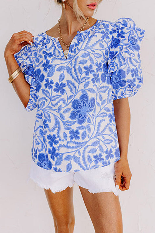 Blusa con estampado floral azul oscuro y manga abullonada con volantes