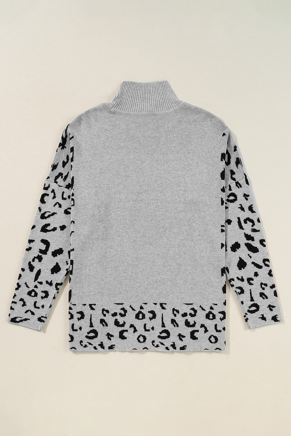 Suéter oversized de cuello alto gris con abertura lateral y estampado de leopardo
