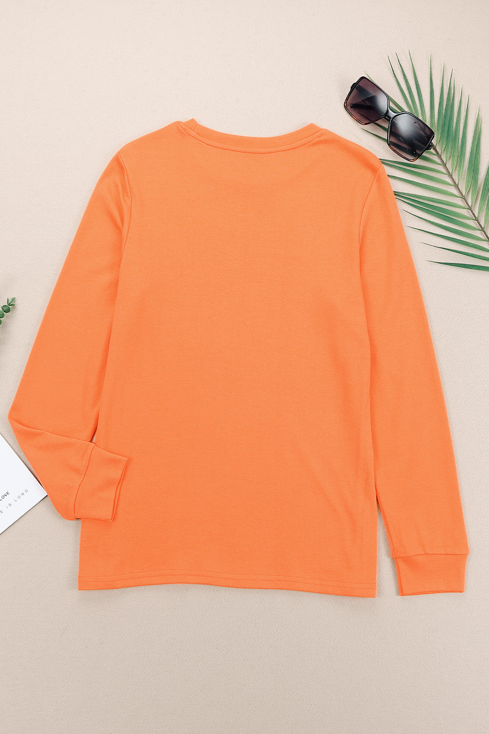 Top naranja liso de manga larga con cuello redondo