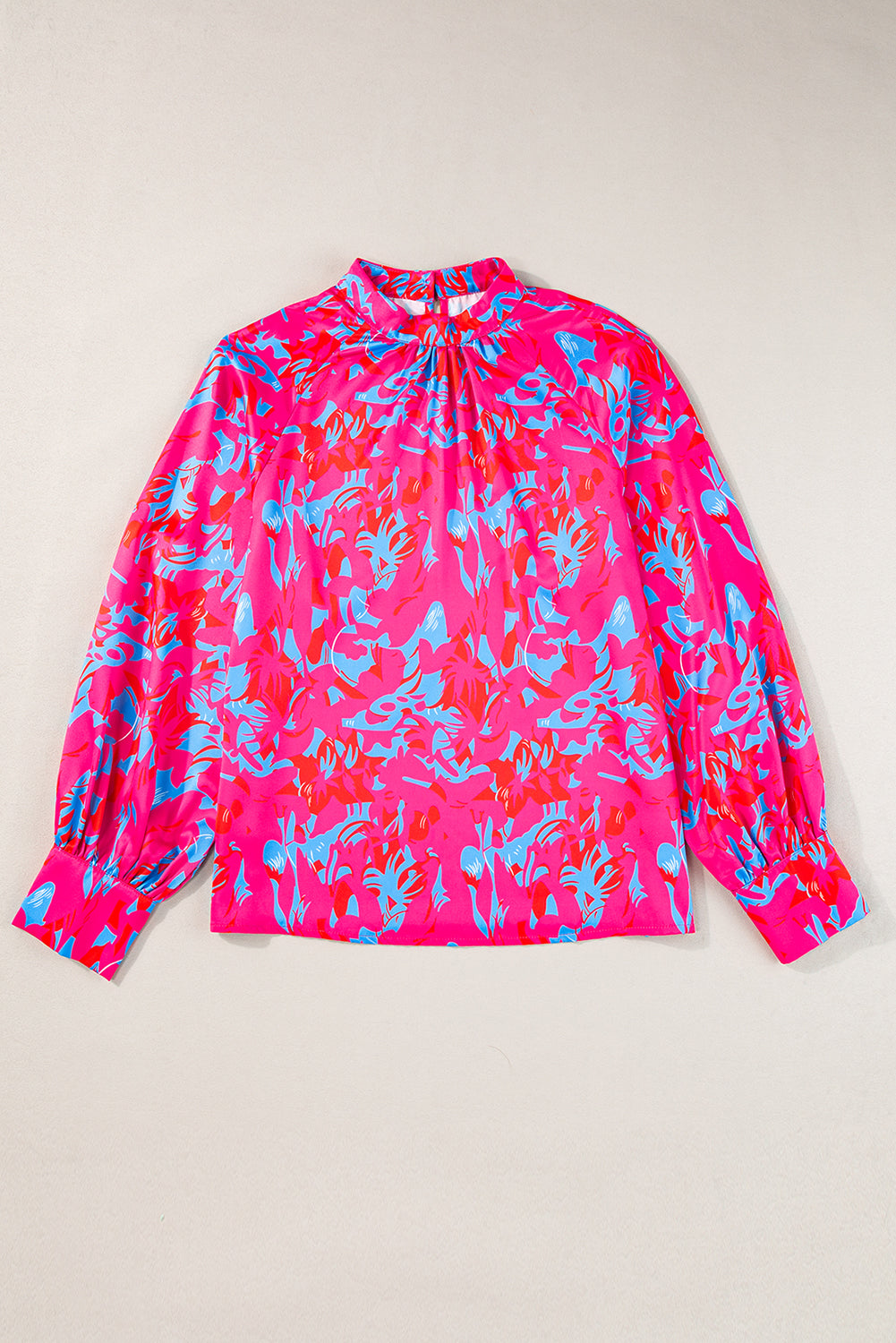 Blusa morada con estampado, mangas abullonadas y cuello alto