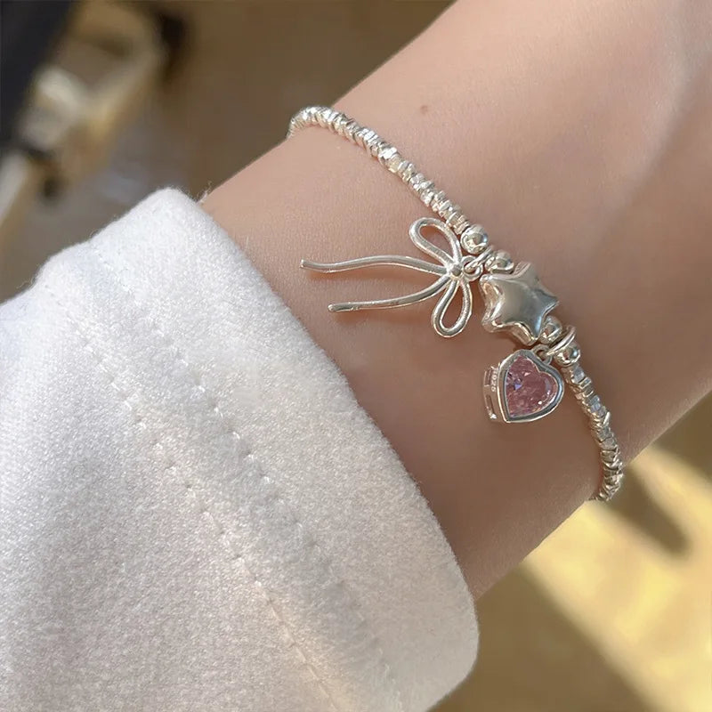 Pulsera y collar con diseño de estrellas, corazones y lazos