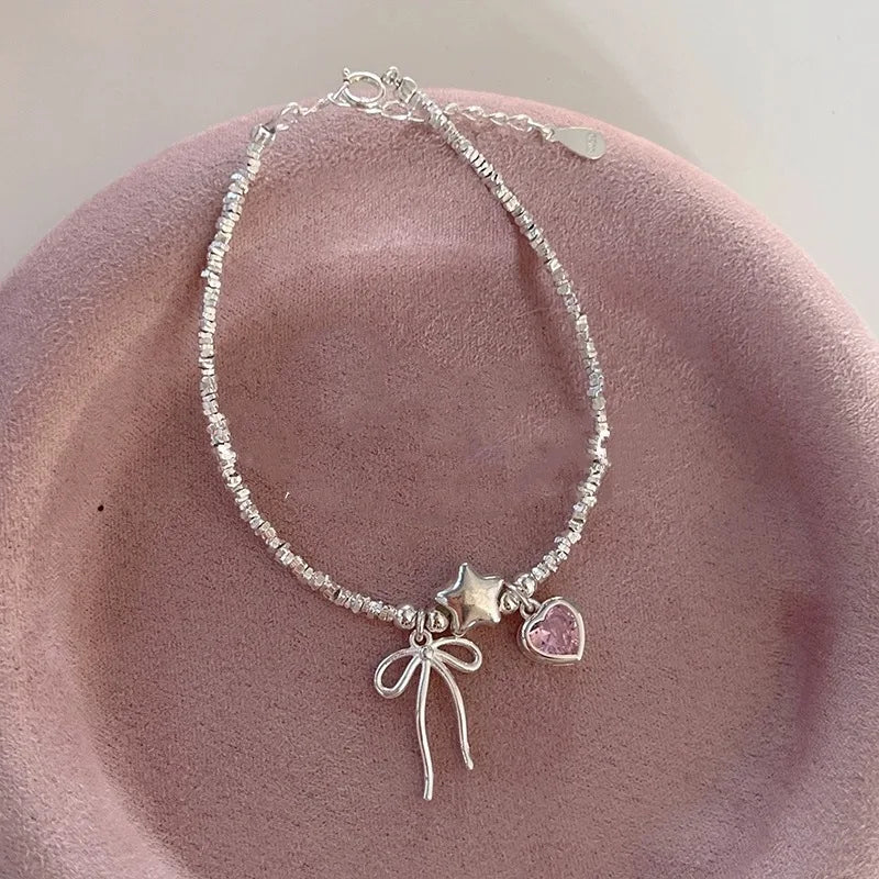 Pulsera y collar con diseño de estrellas, corazones y lazos
