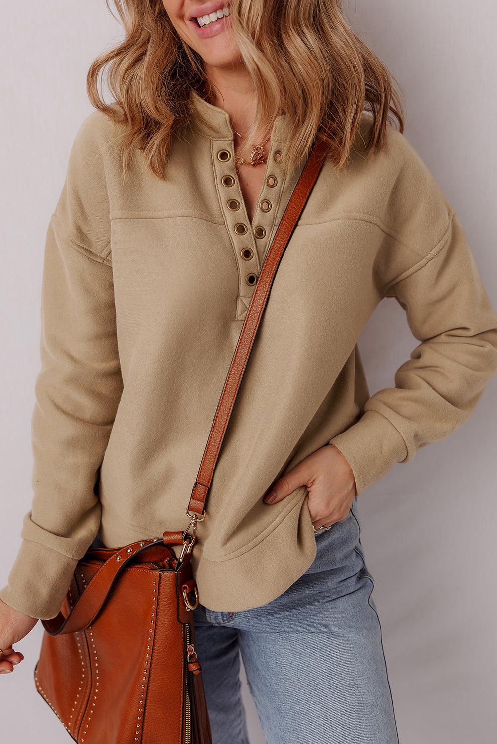 Sudadera con cuello de pico, detalles de ojales y color beige francés claro