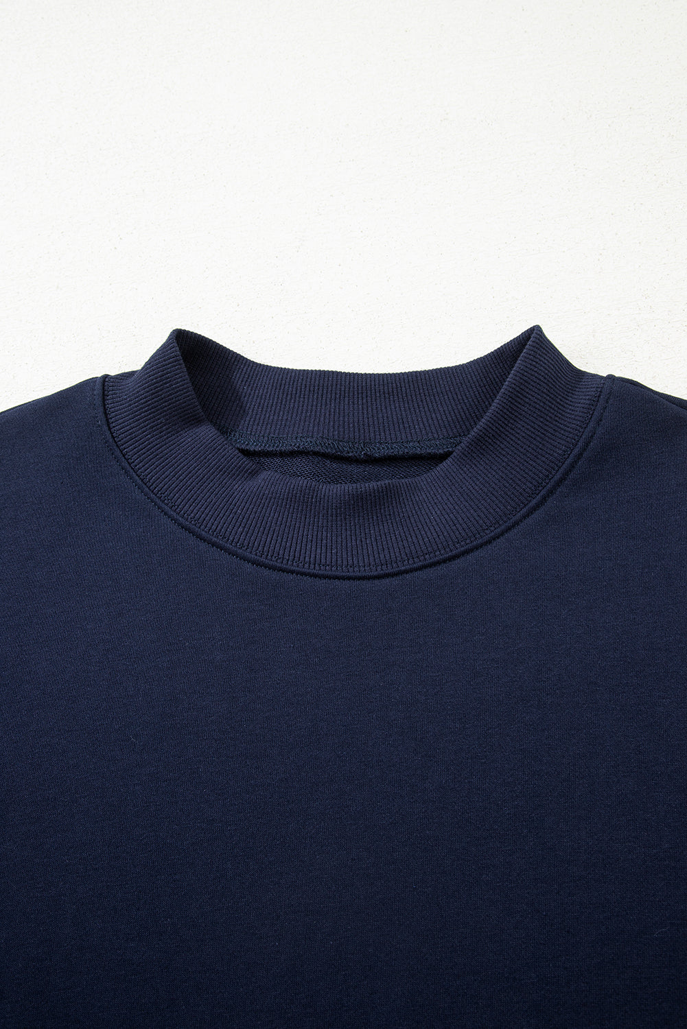 Top de talla grande azul marino con cuello redondo acanalado y volantes escalonados