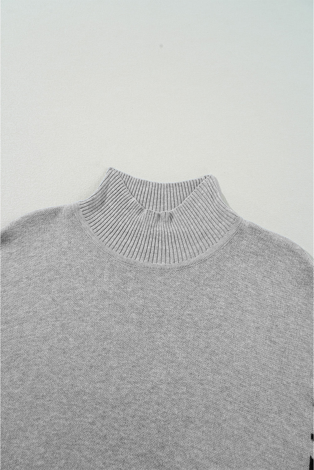 Suéter oversized de cuello alto gris con abertura lateral y estampado de leopardo