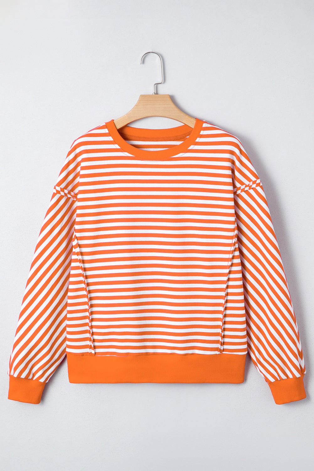 Top tipo jersey casual de hombros caídos con costuras expuestas a rayas naranjas