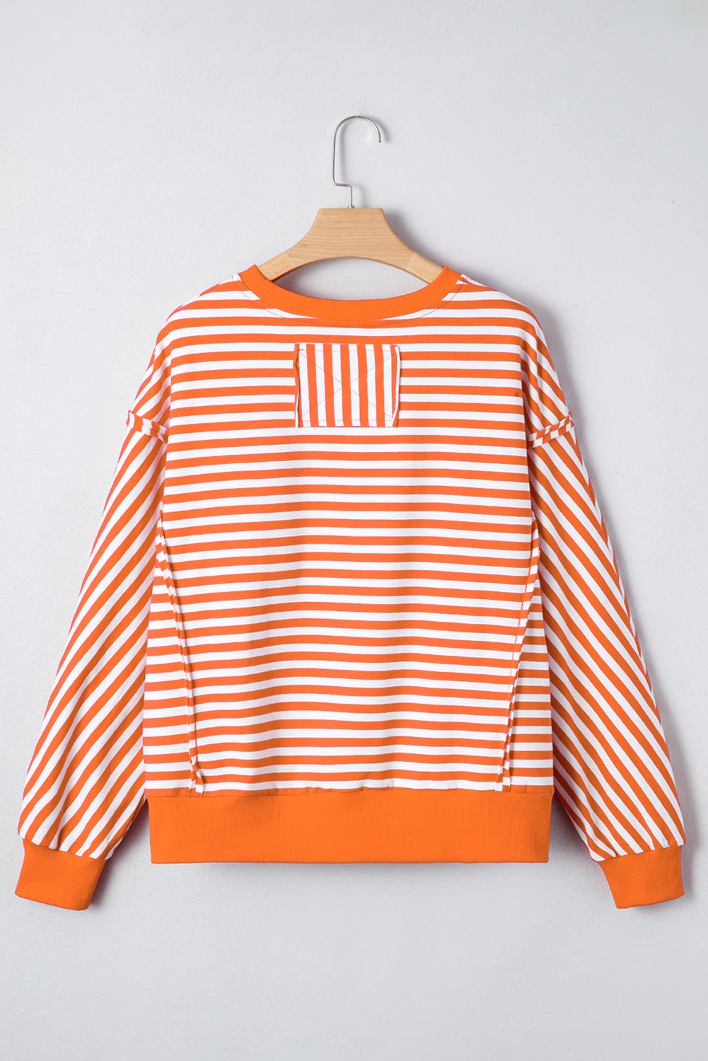 Top tipo jersey casual de hombros caídos con costuras expuestas a rayas naranjas