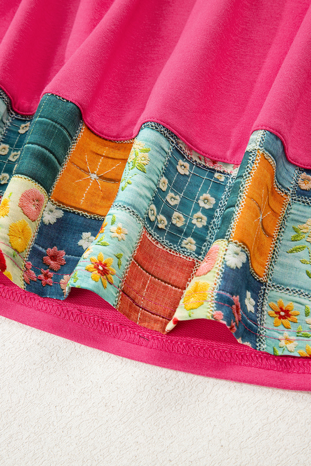Top informal con bajo floral patchwork rosa fresa y cuello redondo