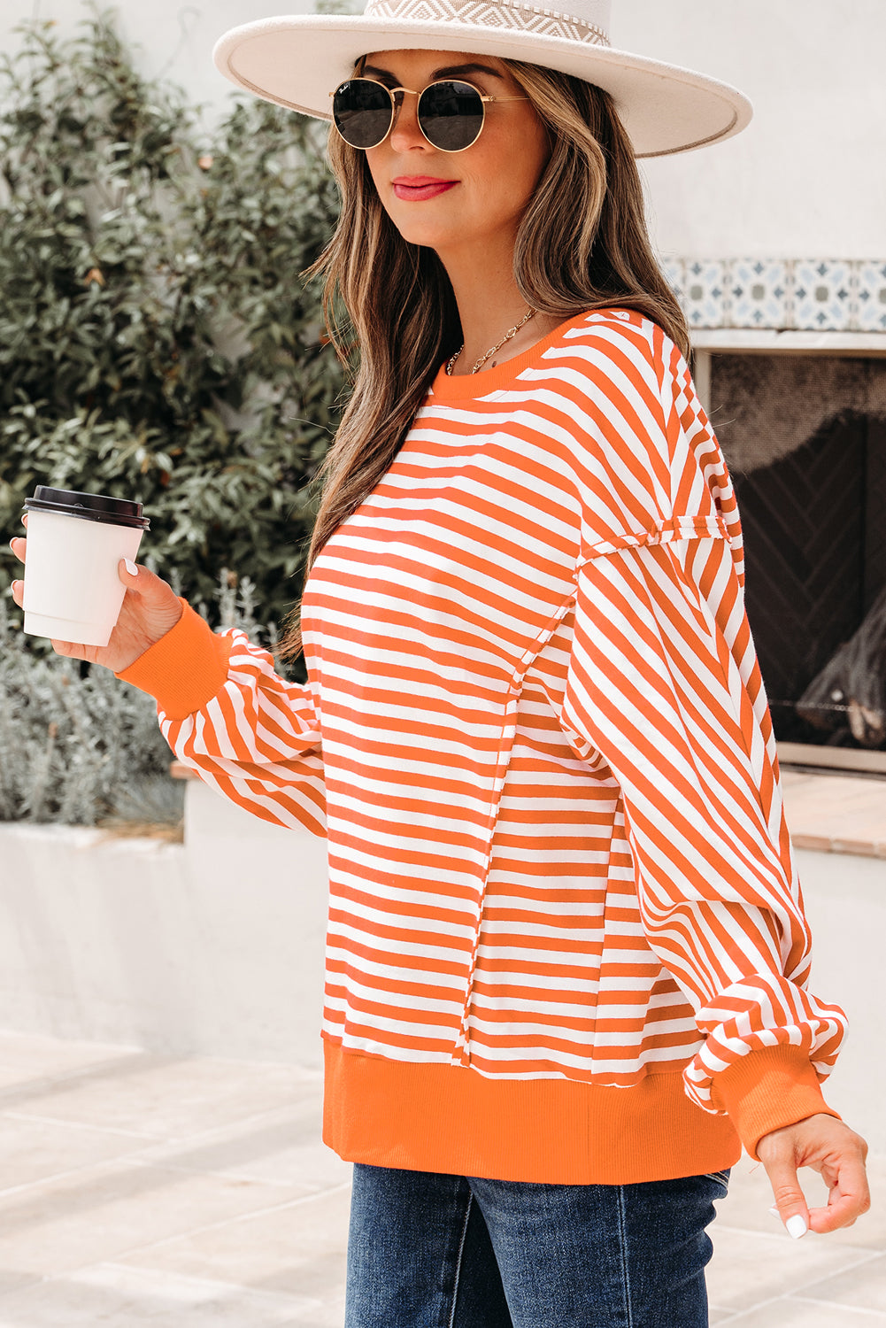 Top tipo jersey casual de hombros caídos con costuras expuestas a rayas naranjas