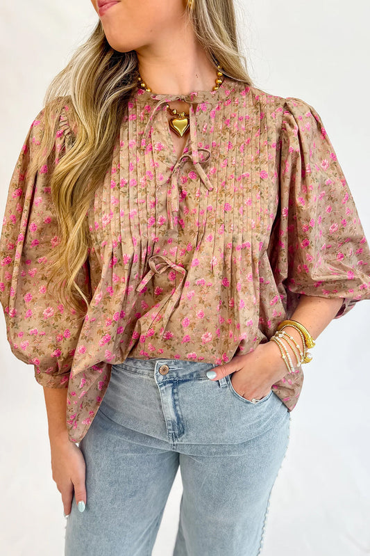Blusa de color beige francés claro con estampado floral, lazo, pliegues en el busto y media manga abullonada